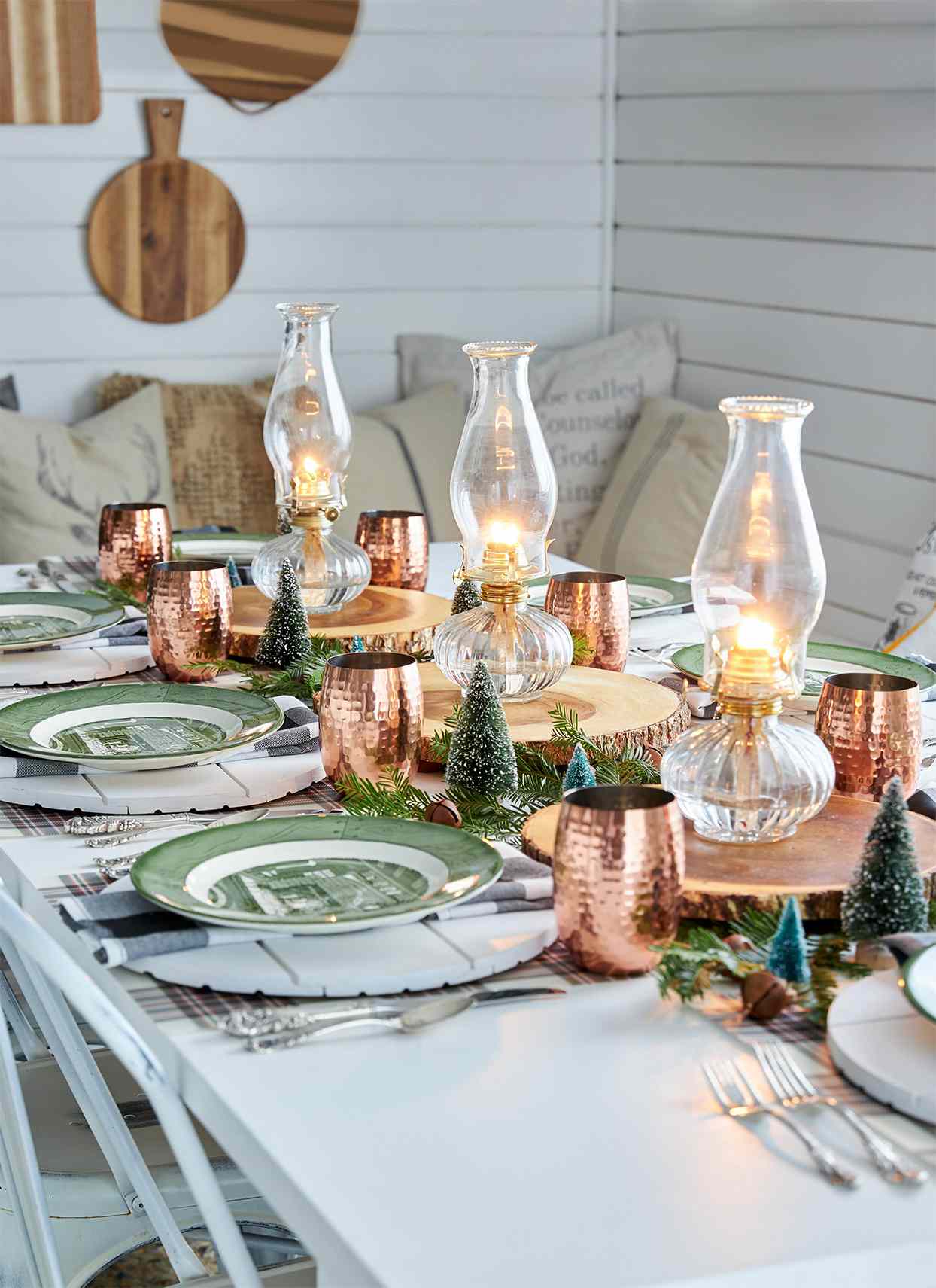 green and copper table setting with lantern centerpieces