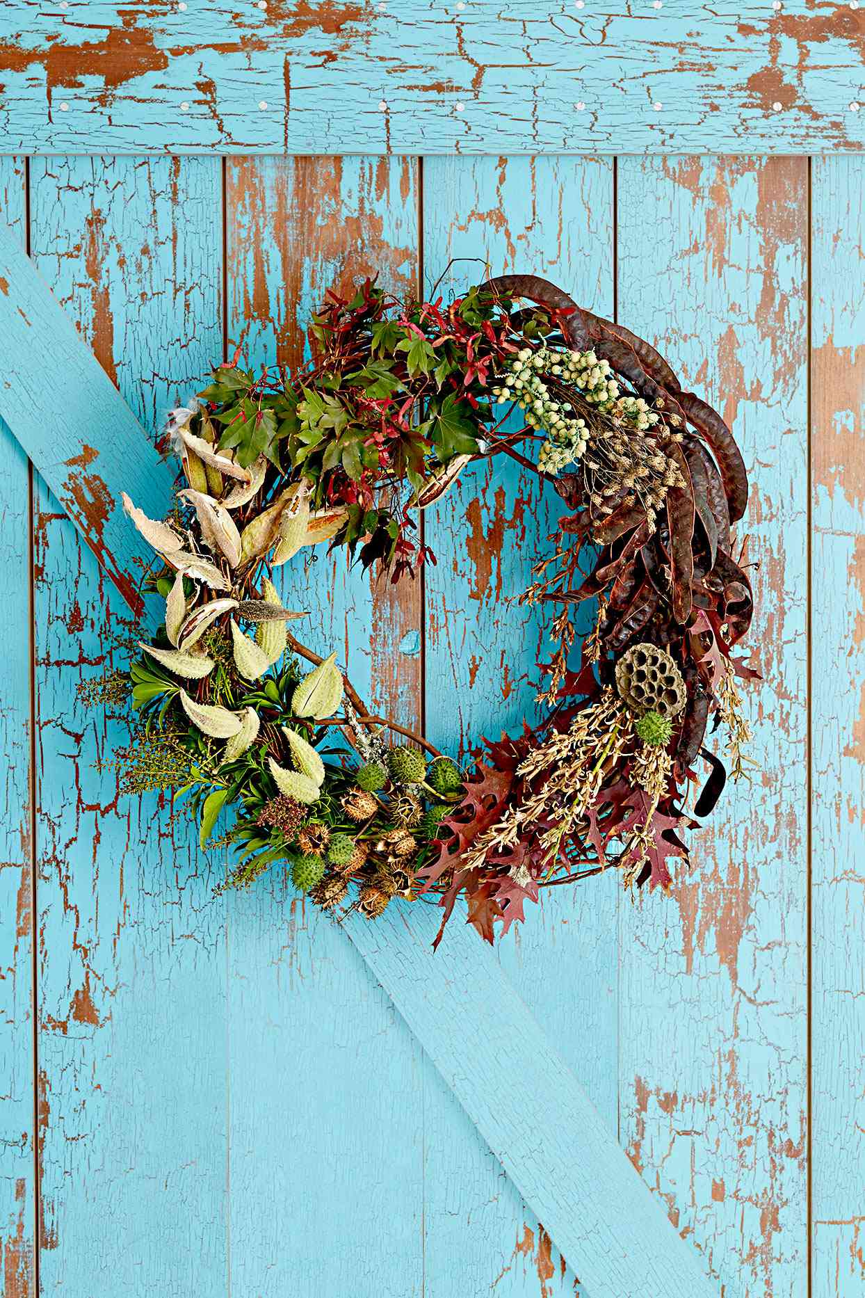 Wreath made of leaves, seed pods, and plants