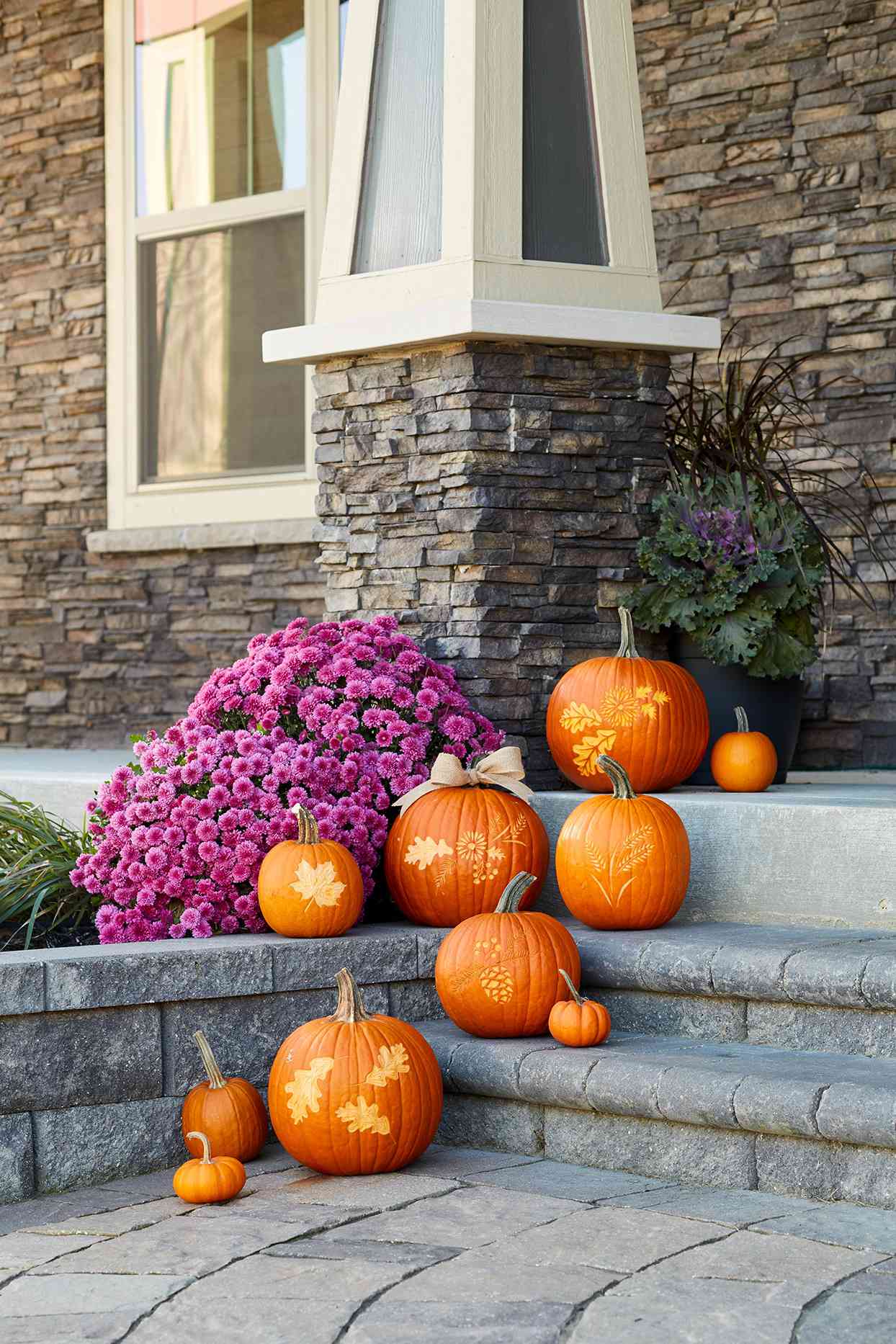 carved pumpkins sitting on stoop