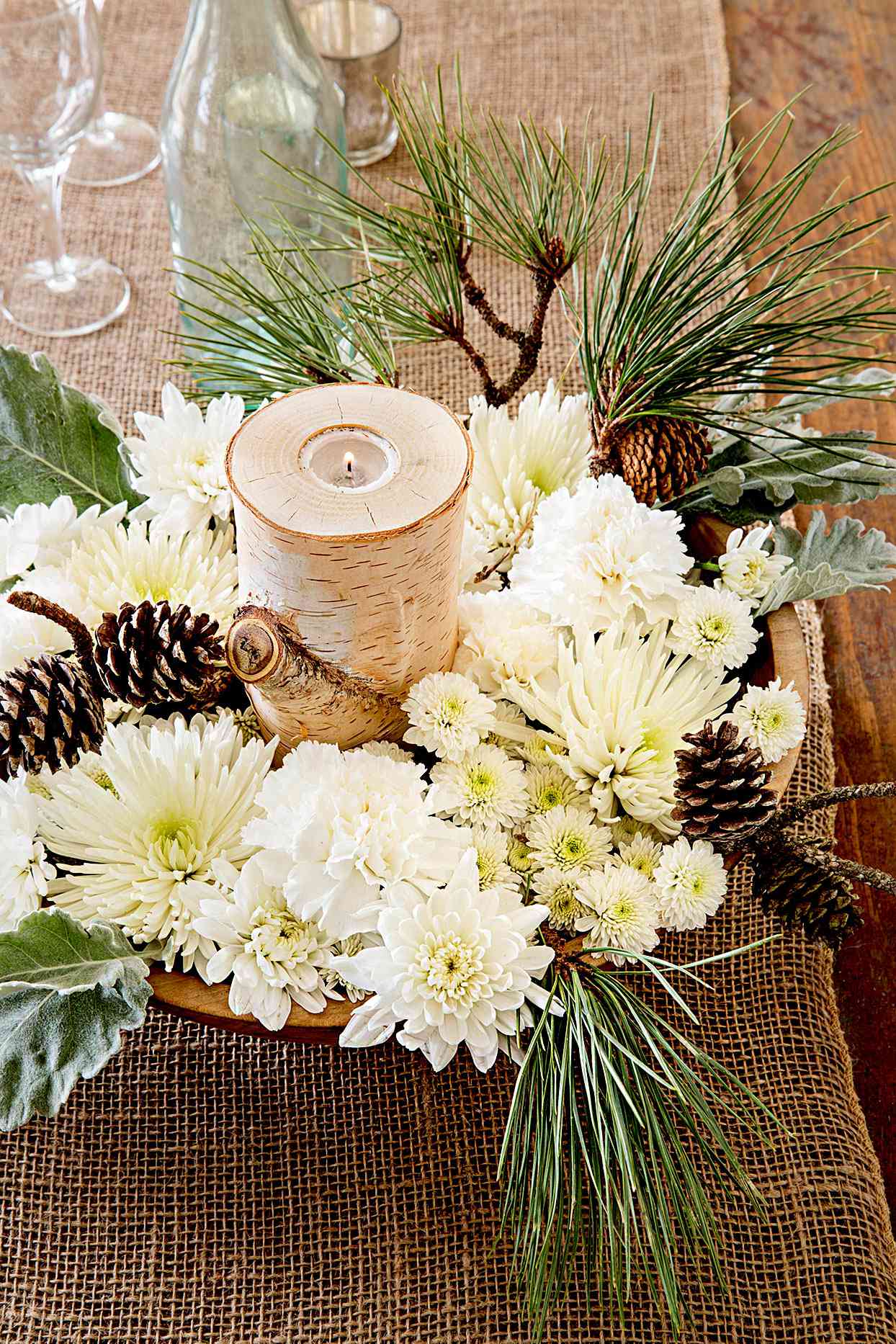Centerpiece made of flowers, evergreens, and pinecones
