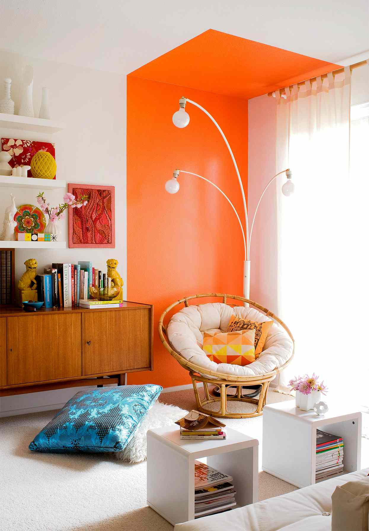 room corner with bright orange two-toned paint and papasan chair