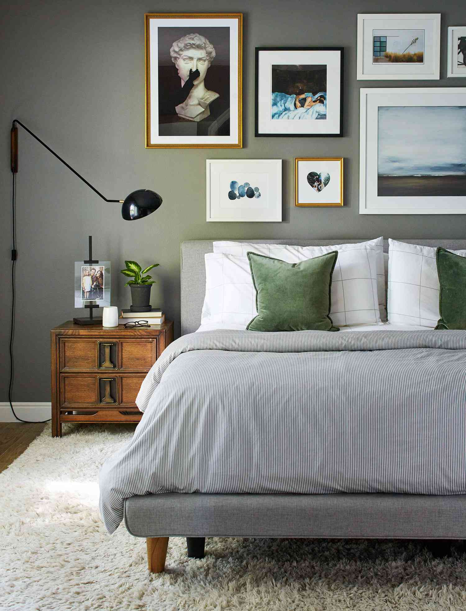 gray bedroom with green pillows bed