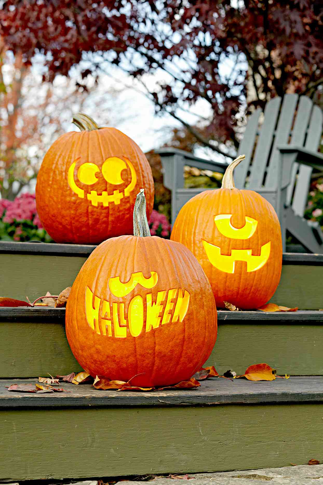 Three carved pumpkins on stairs