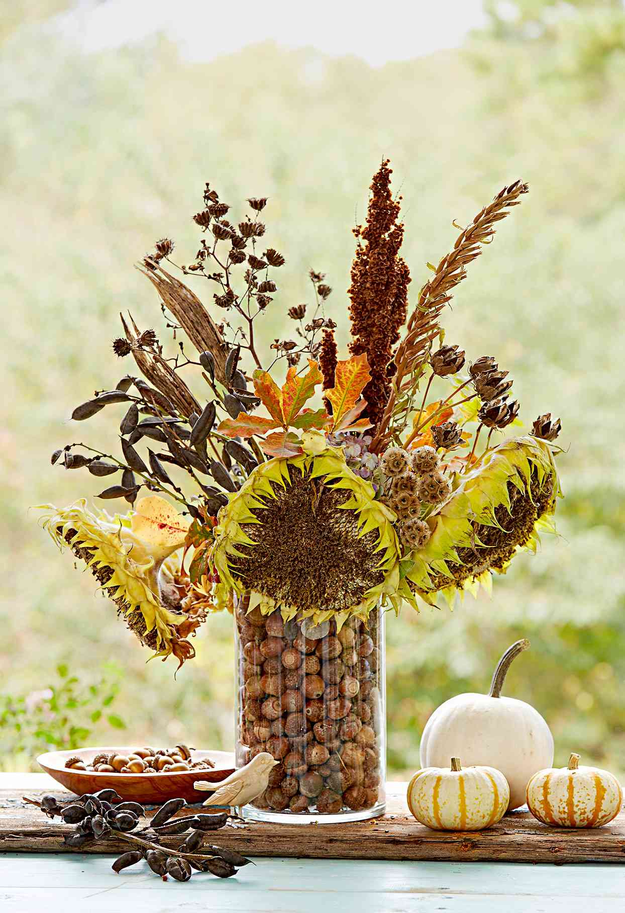 Vase with sunflowers and other plants