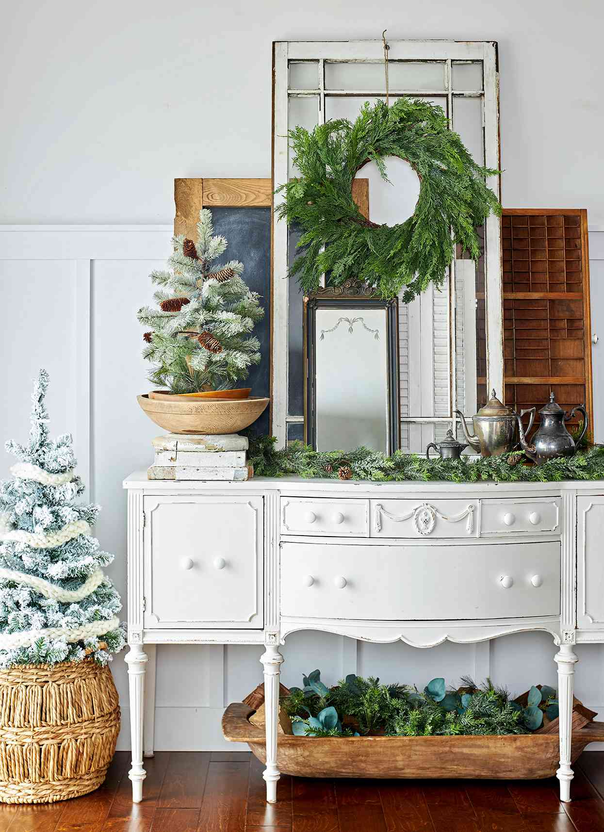 vintage buffet with tea pots, mirror, and Christmas greenery