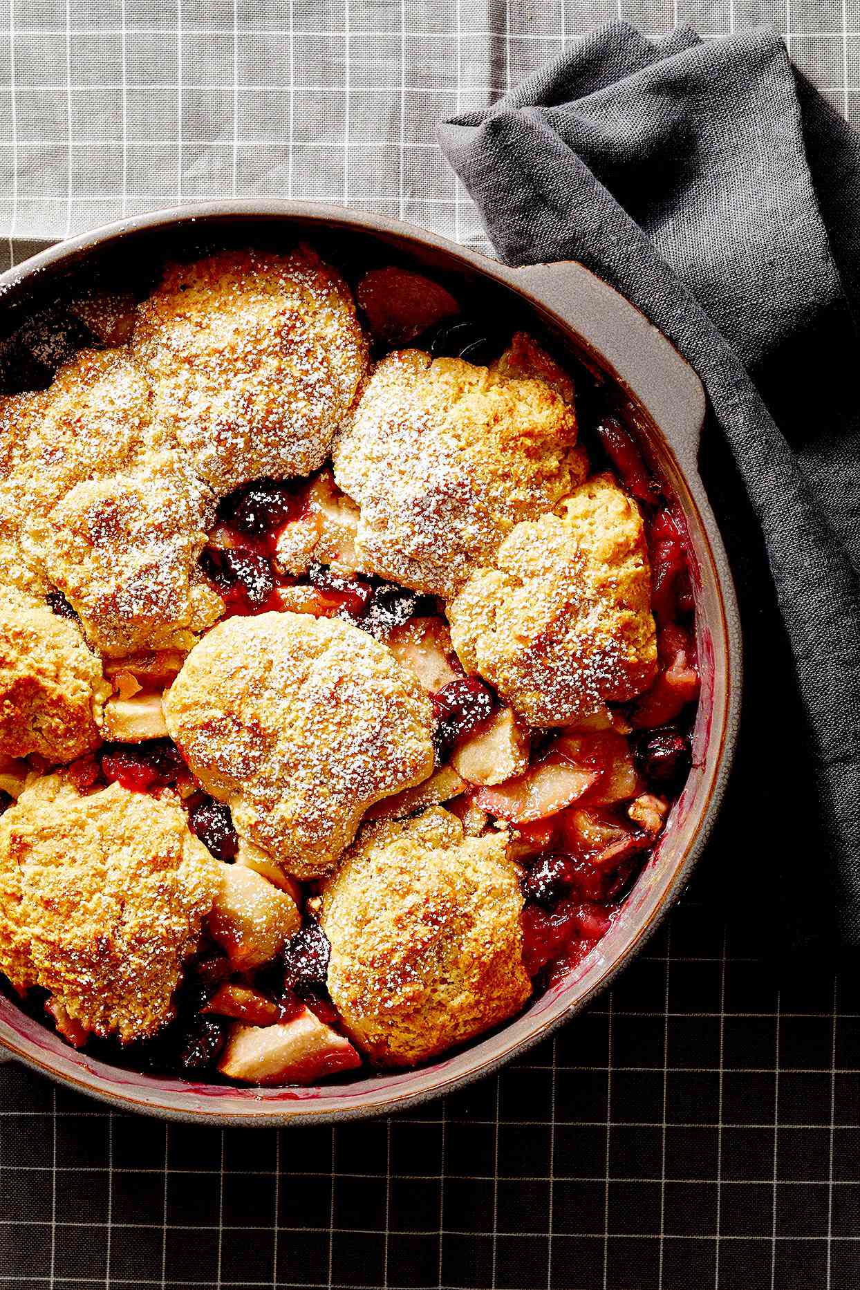 Pear, Apple, and Cranberry Cobbler in casserole dish on a wire rack