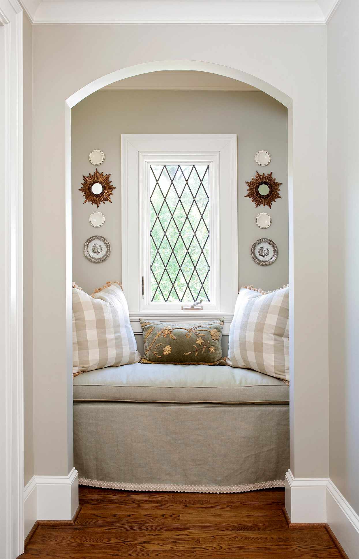 reading nook with window, neutral textiles and symmetric wall art