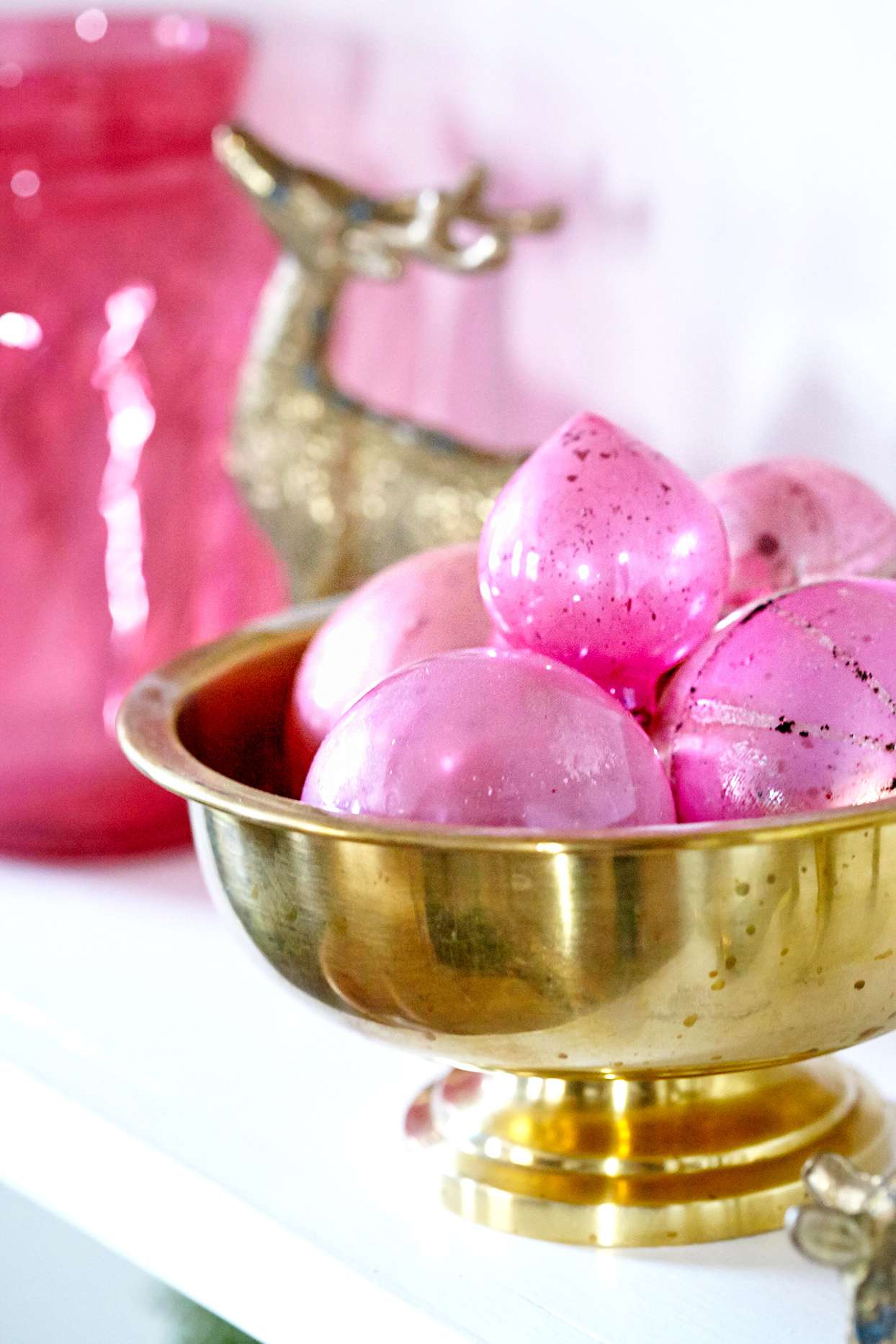 Pink ornaments in gold bowl