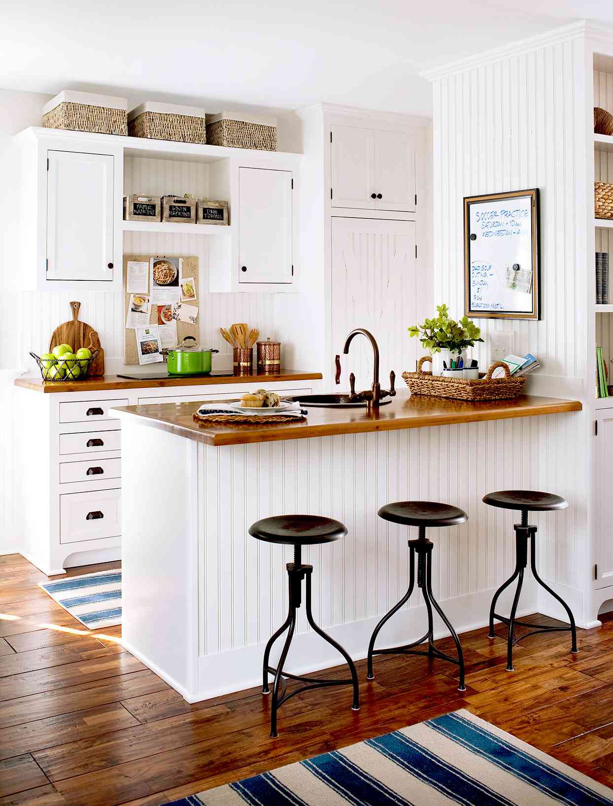 White kitchen with bar seating and stools