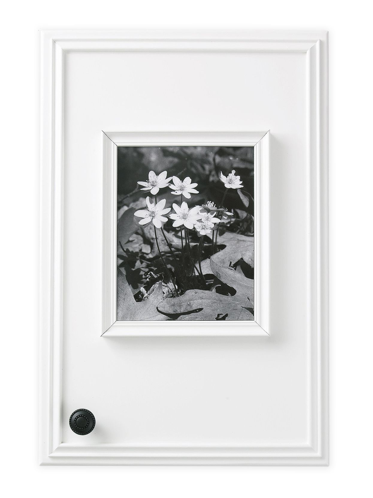 white cabinet with attached frame and black and white print