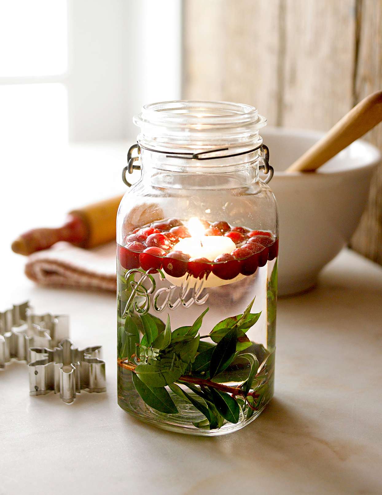 Mason jar lights with cranberries and leaves