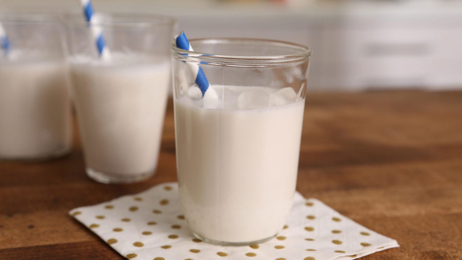 cashew milk in glasses with striped straws