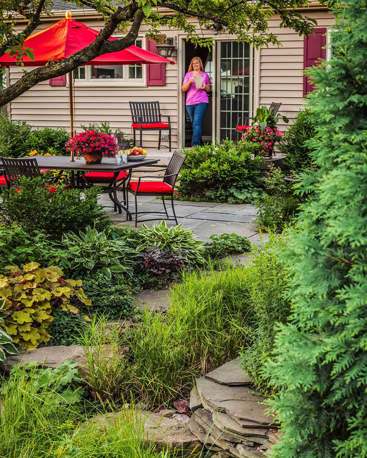 woman walking into backyard patio garden