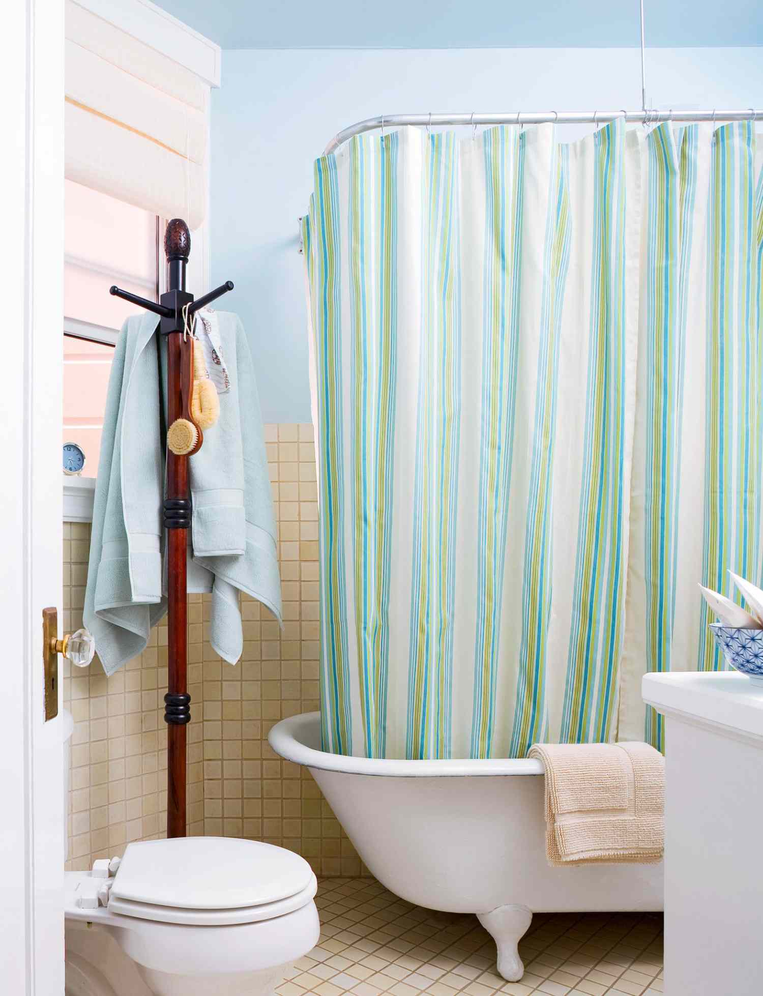 bathroom with free-standing tub and coat rack for towels