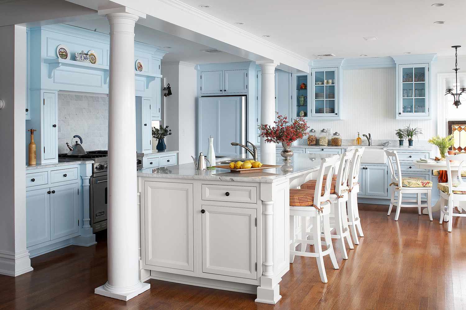blue kitchen with white chairs and table