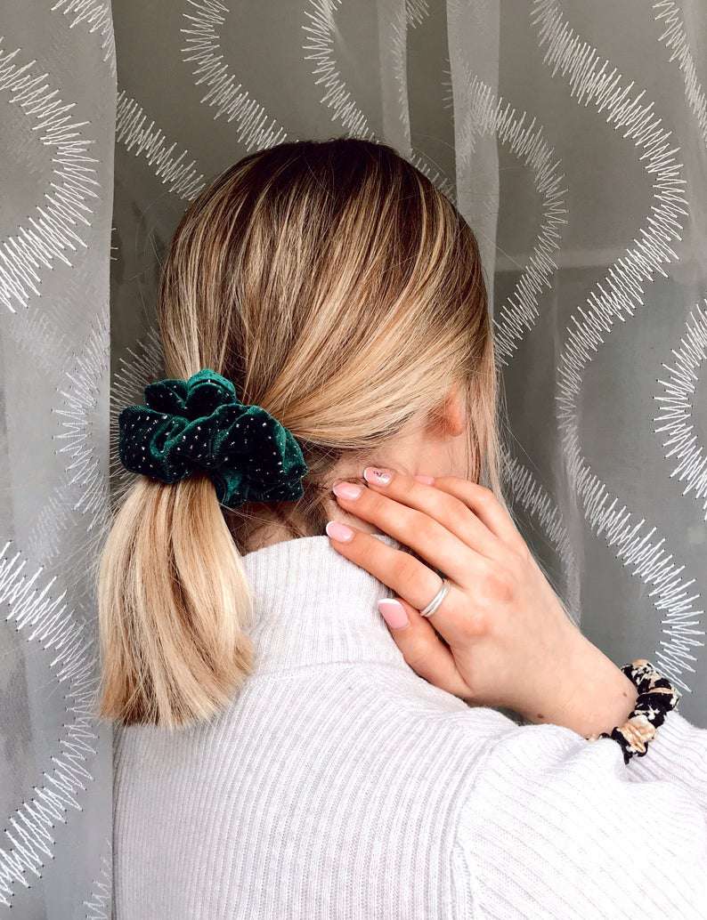 woman with blonde hair wearing green scrunchie around ponytail