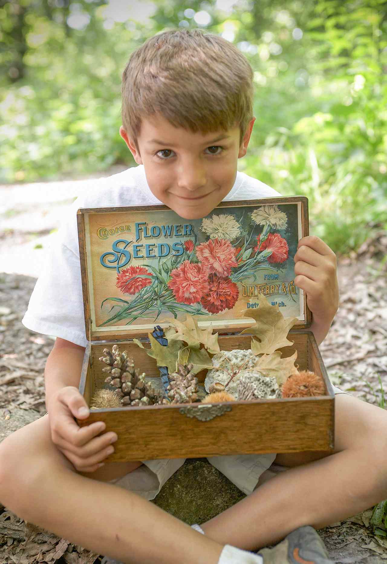 boy holding box of scavenger hunt items