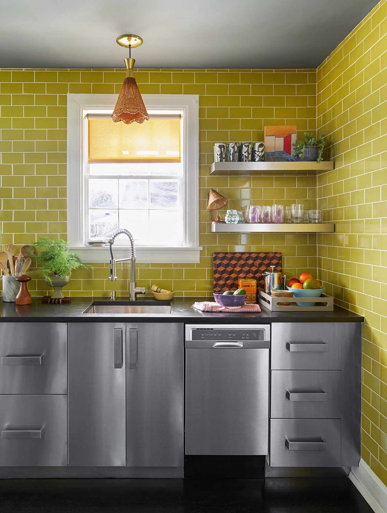 stainless steel kitchen green brick wall
