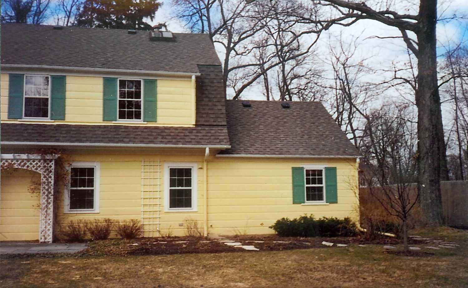 Before photo Yellow Grand Colonial Manor with green shutters