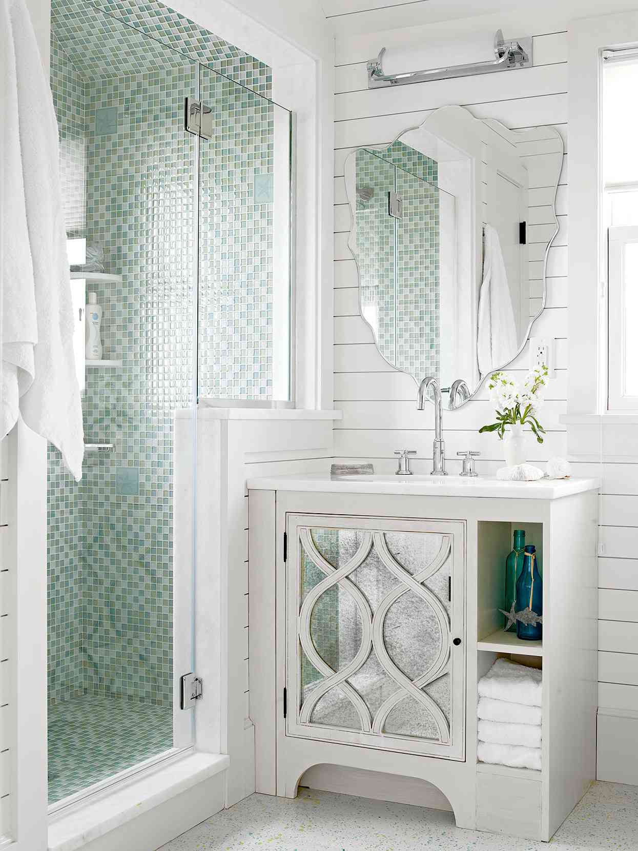 cottage-style bathroom with blue-green shower tile