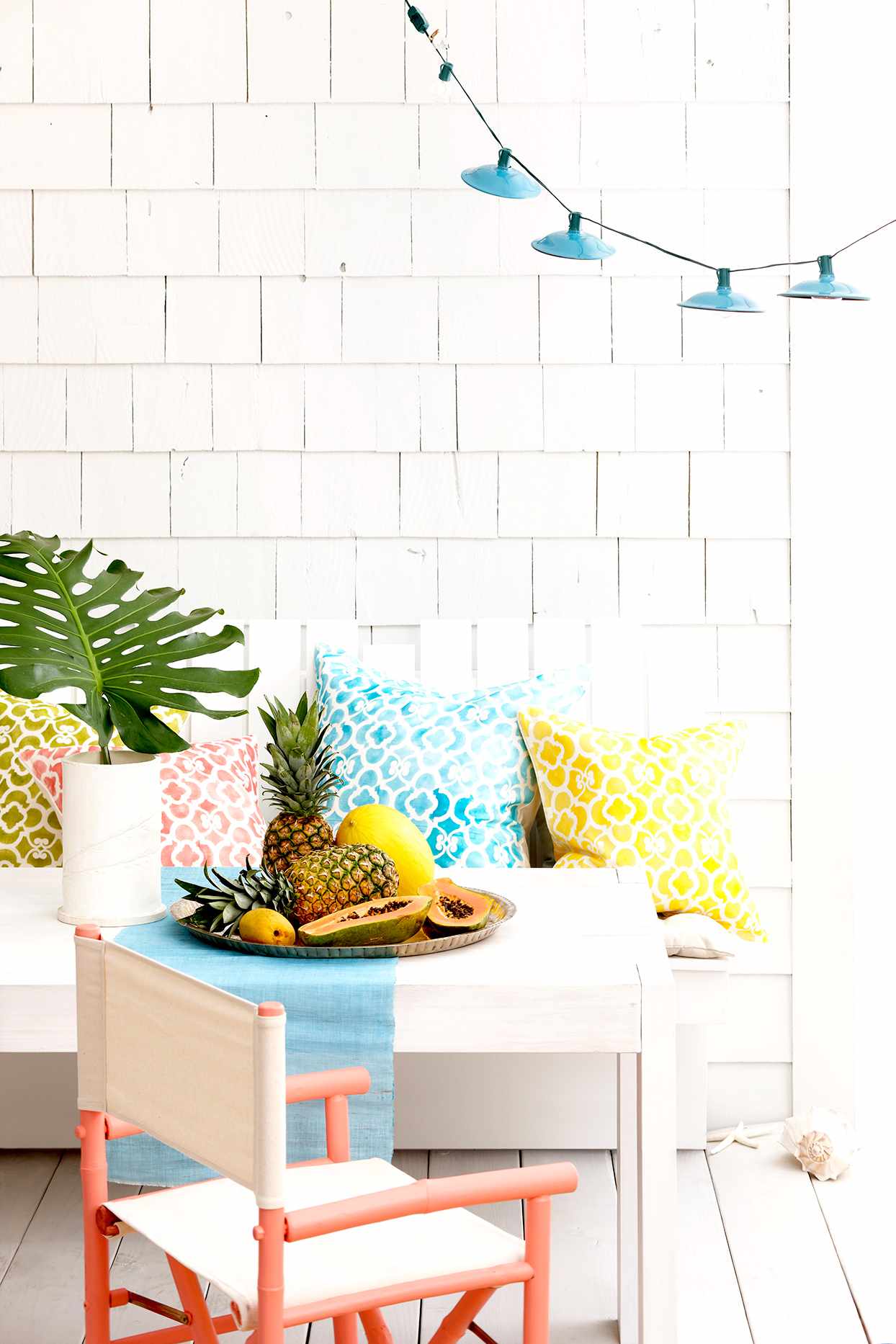 Patio seating with white furniture and colorful pillows