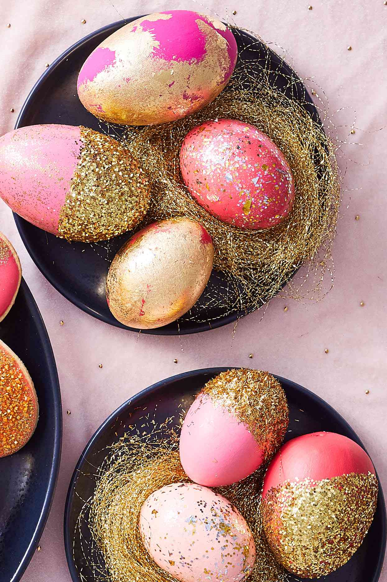 seven painted pink Easter eggs covered with gold accents