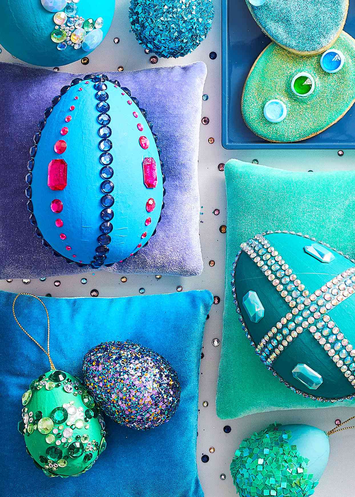 five painted Easter eggs covered in sequins and glitter