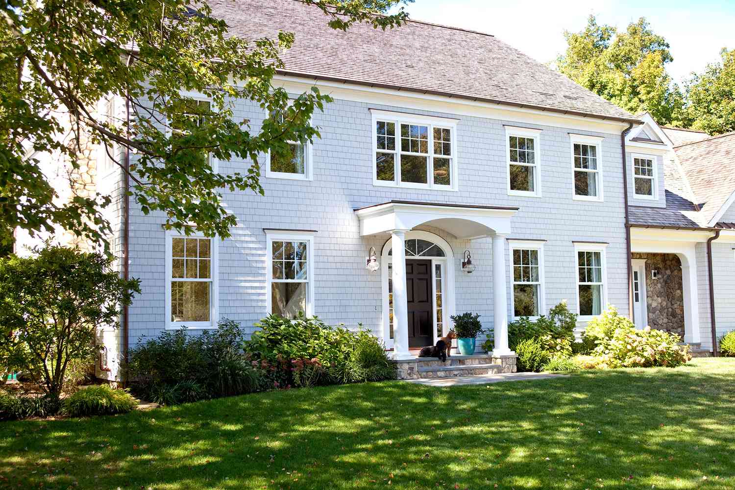 Blue colonial home with white column entryway