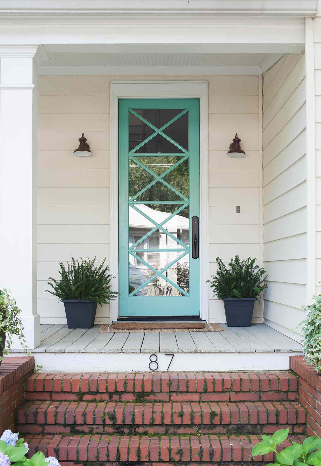 brick steps white home porch teal front door