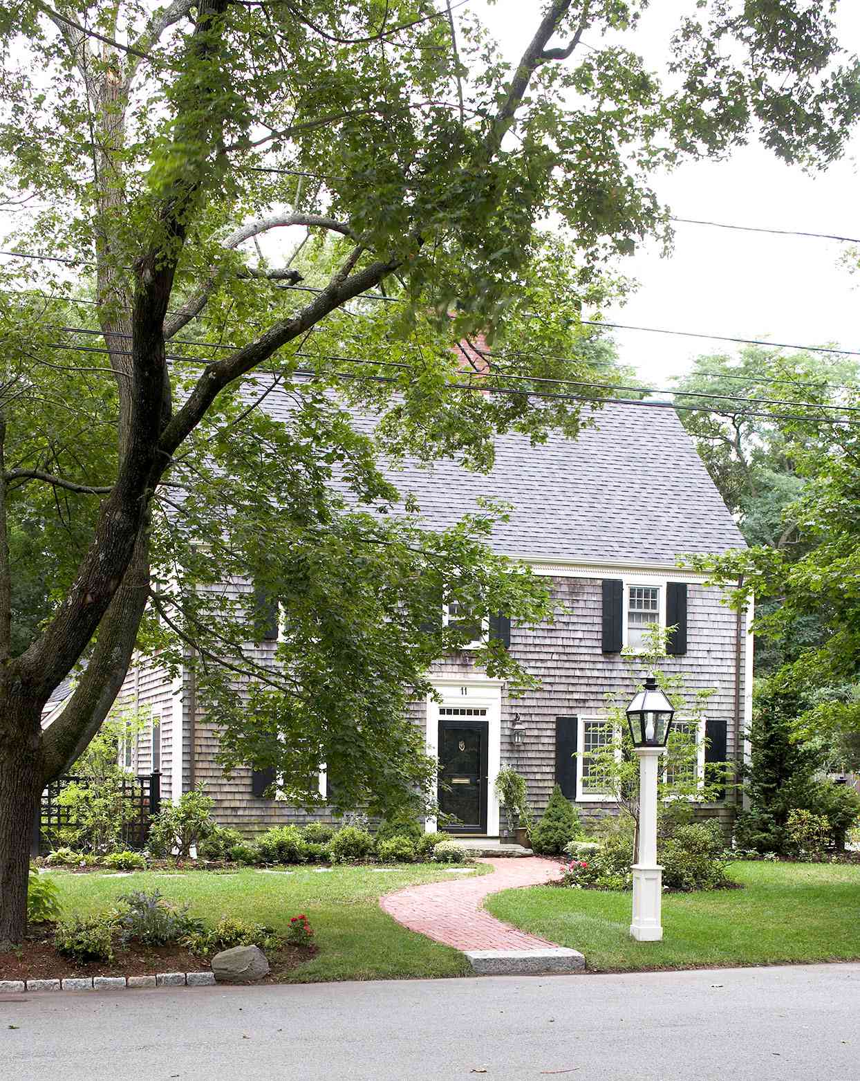 Colonial home with brick walkway