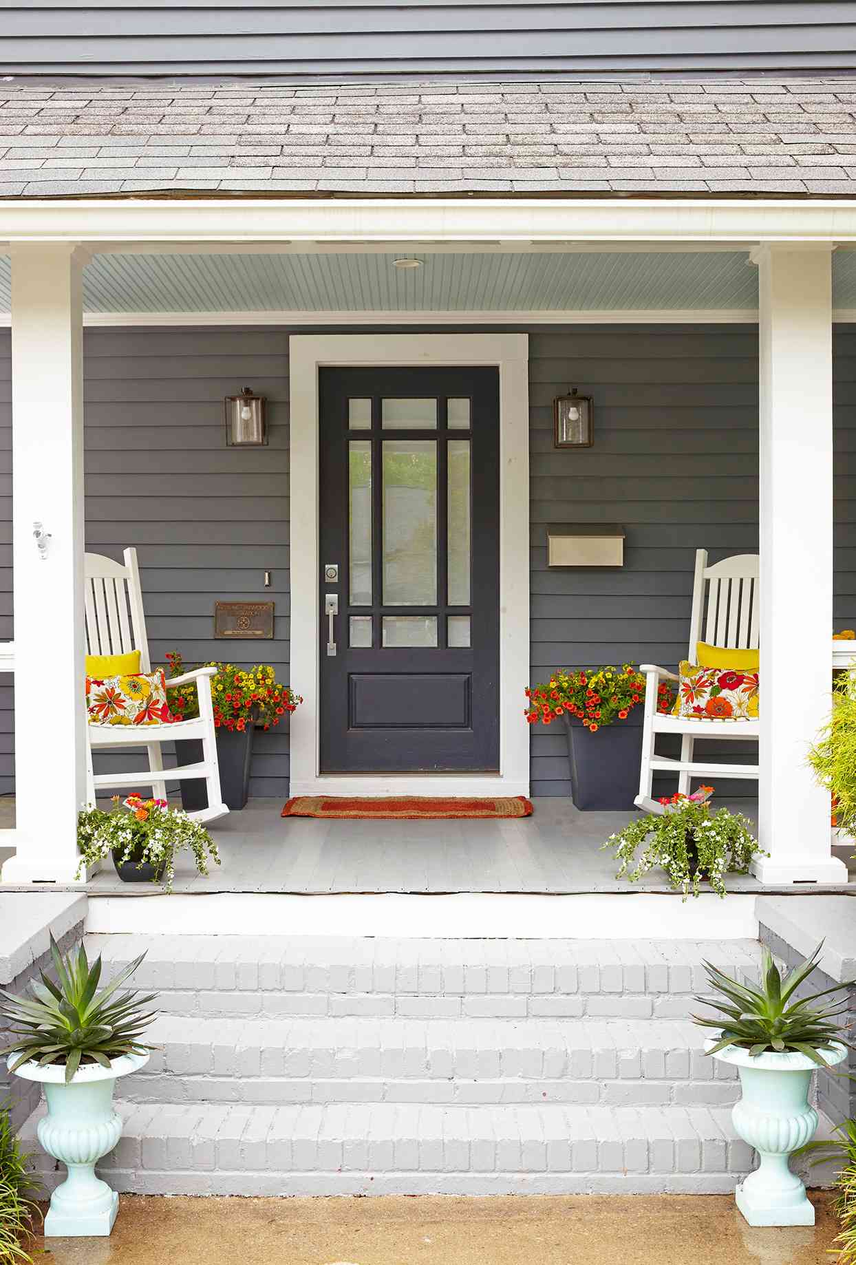 house with gray siding and charcoal door and white columns