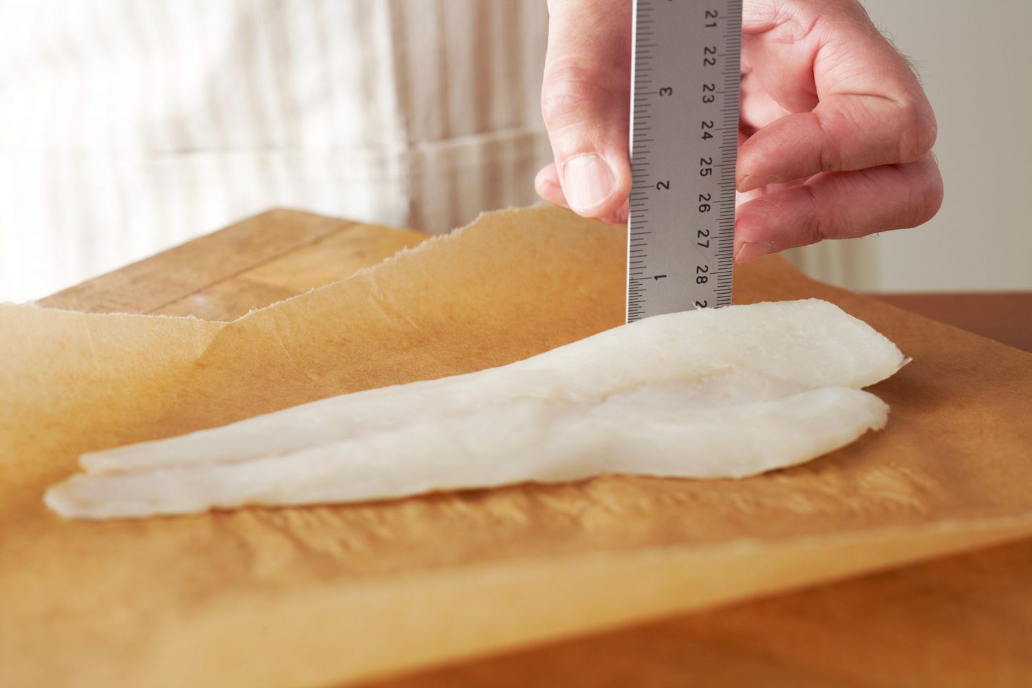 measuring raw fish with ruler