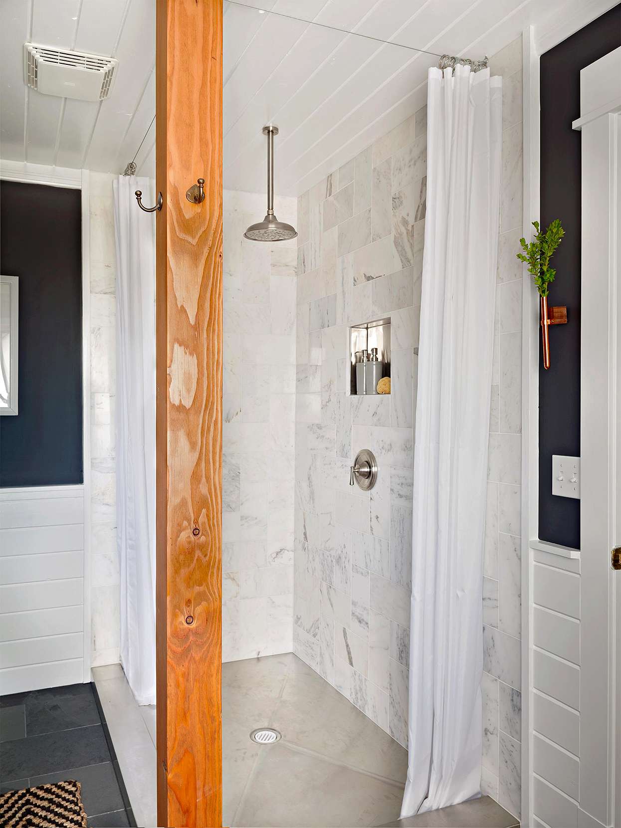wood beam and hanging curtains in tile cornered shower