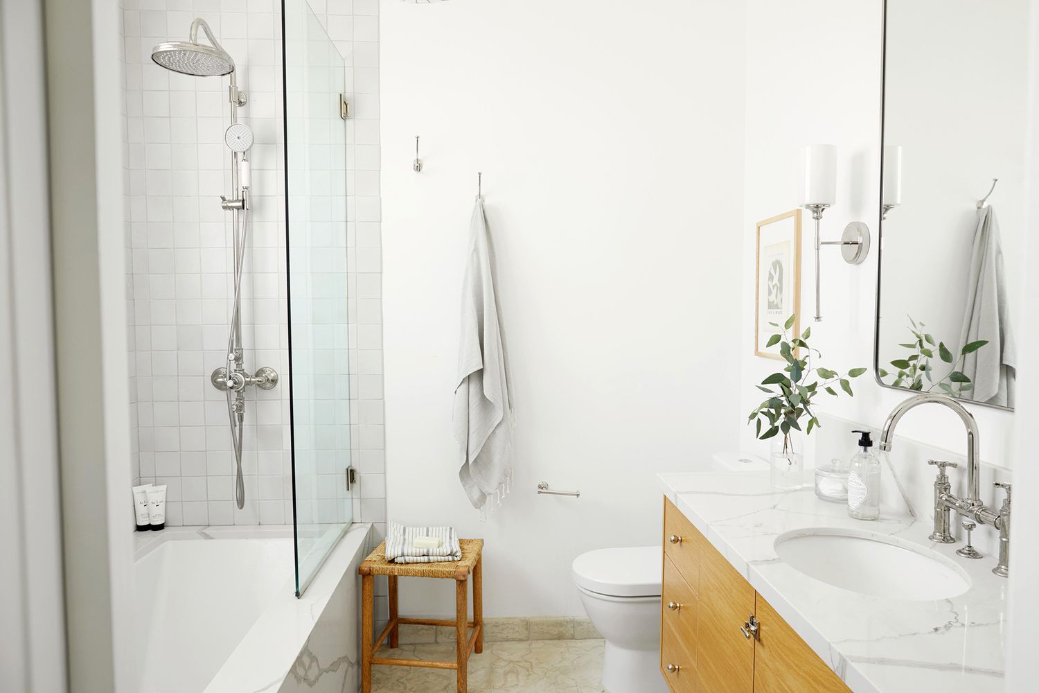 white and light wood bathroom with small plant