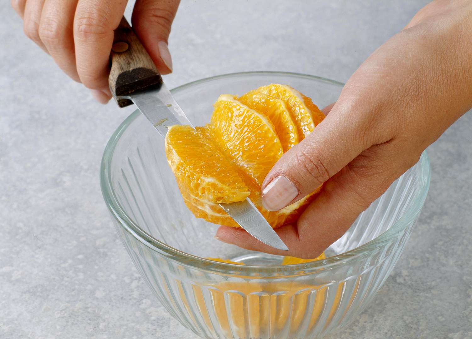 Cutting sections of orange