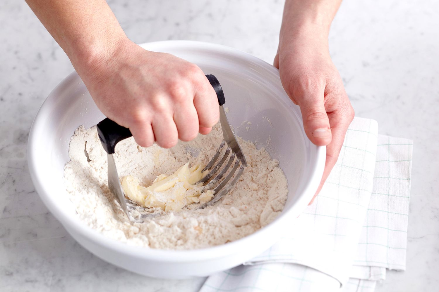 Using tool to cut butter into flour
