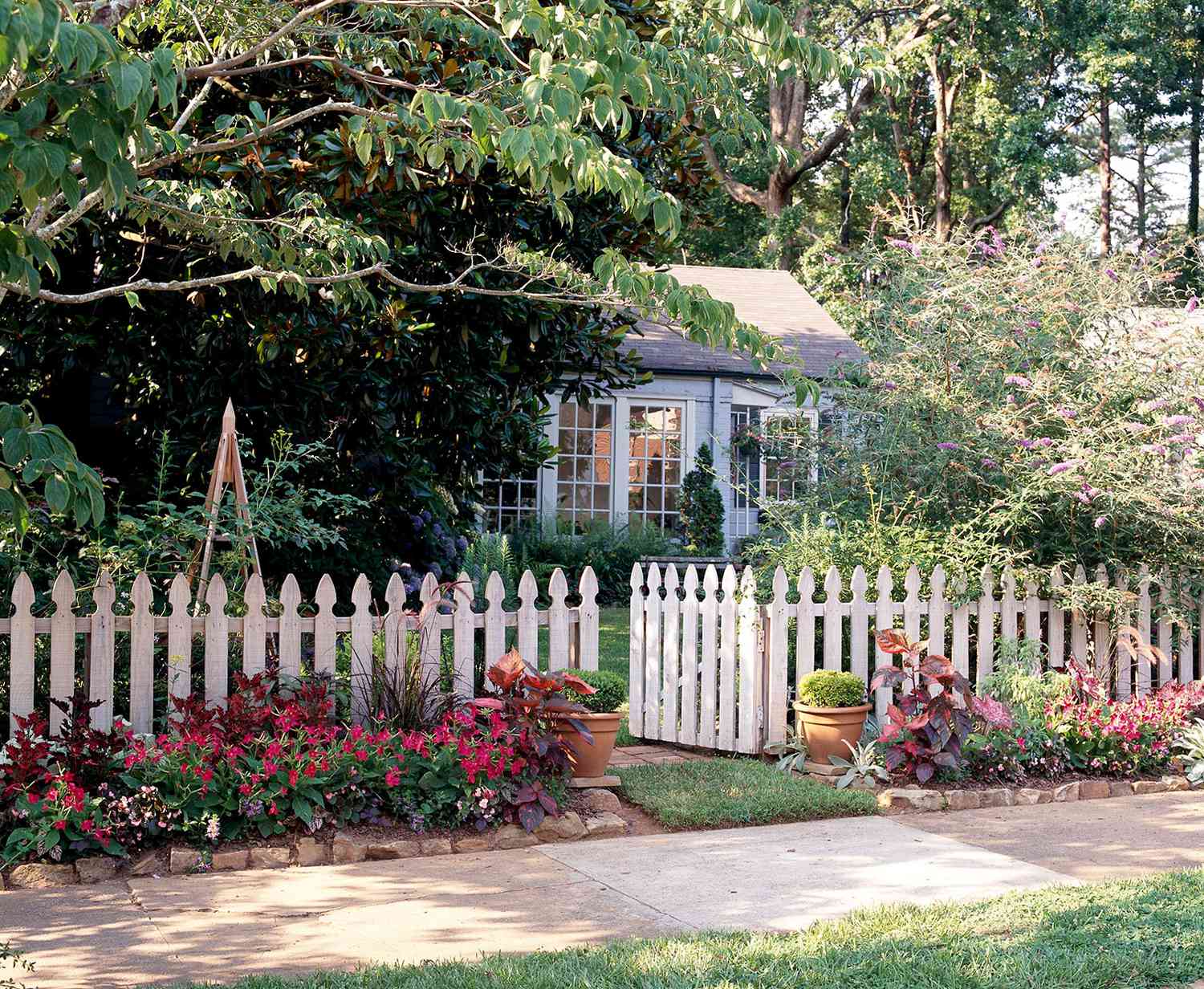 House with white picket fence and plants