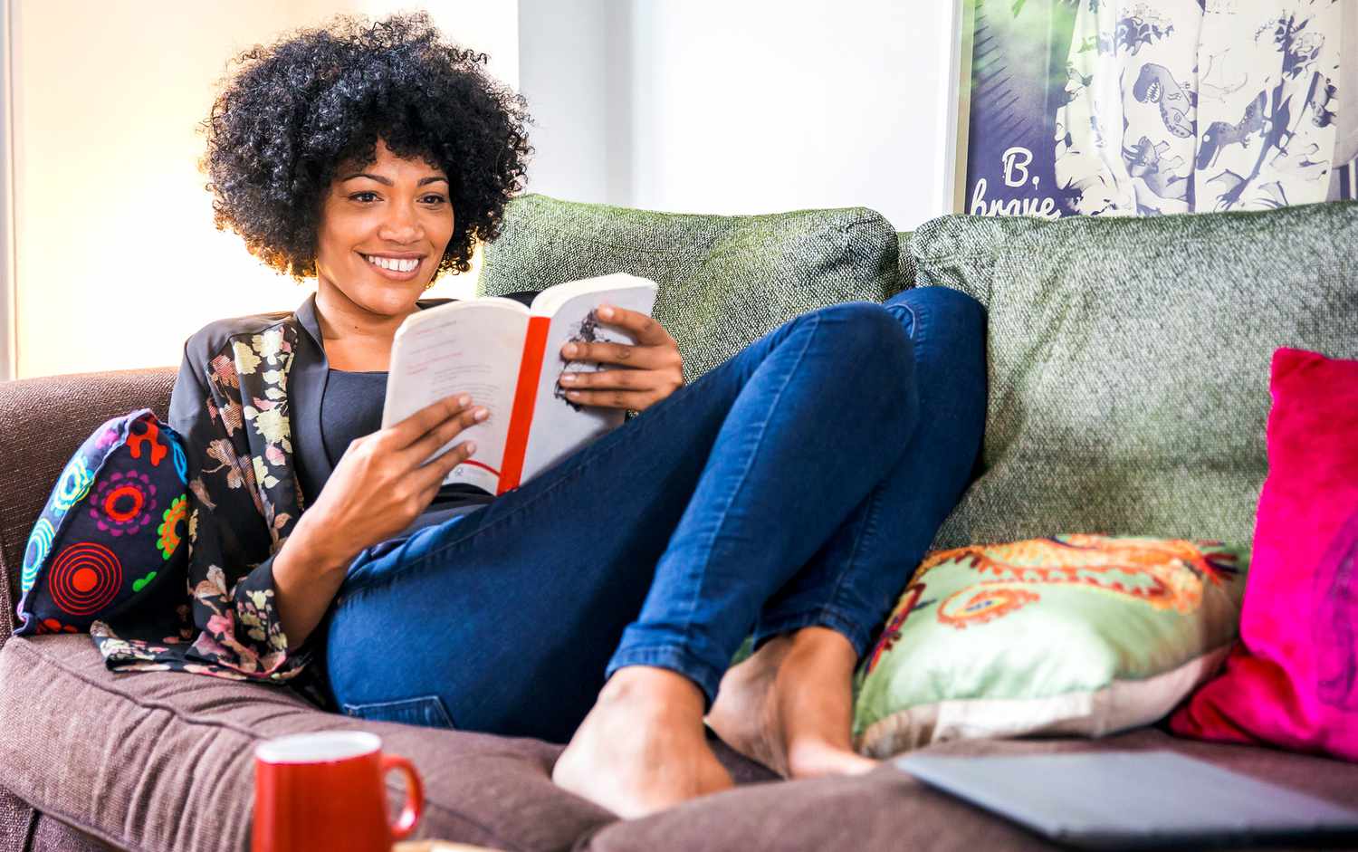 African American woman reading on the sofa