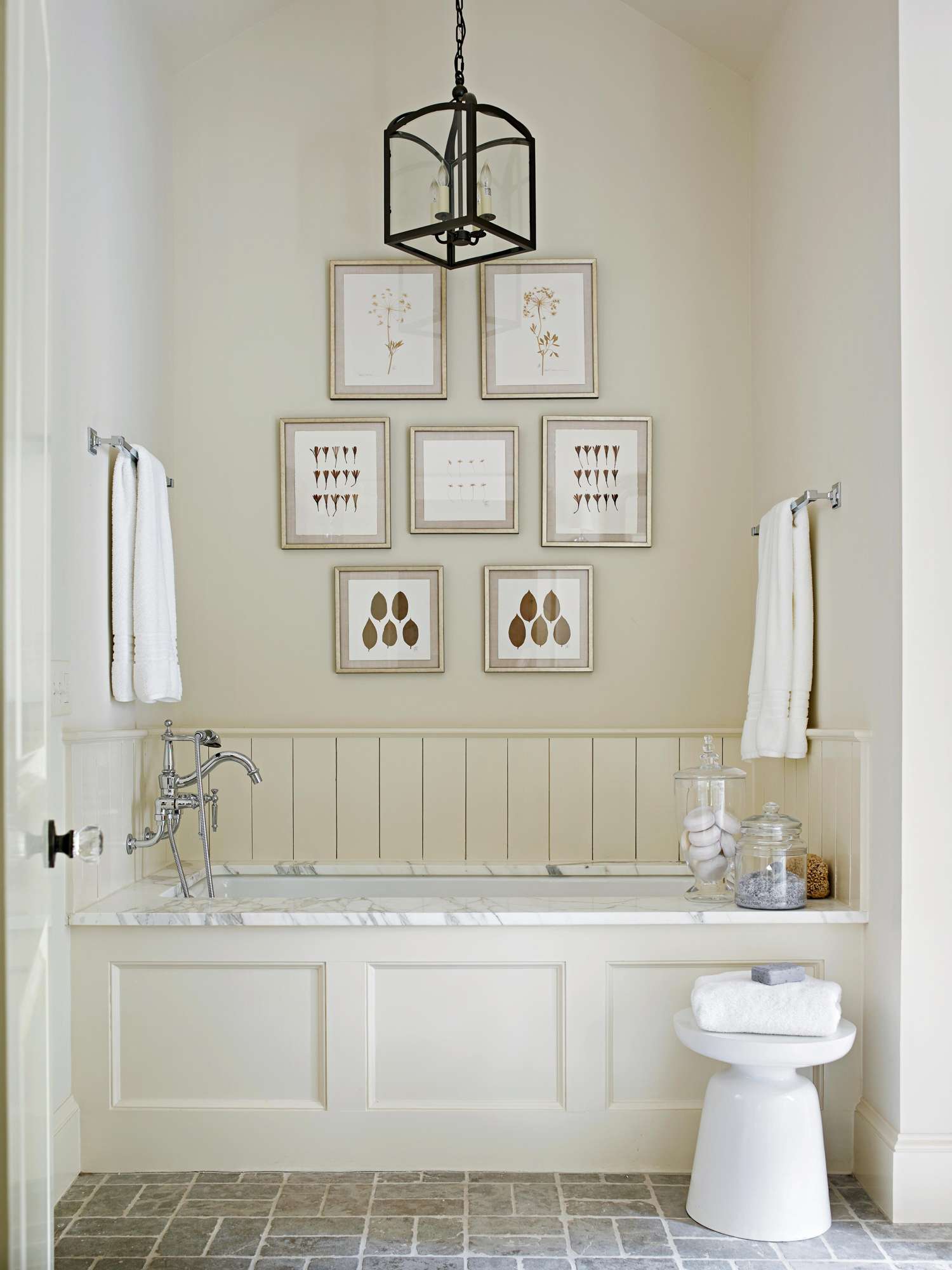 cream colored bathroom with gallery wall art