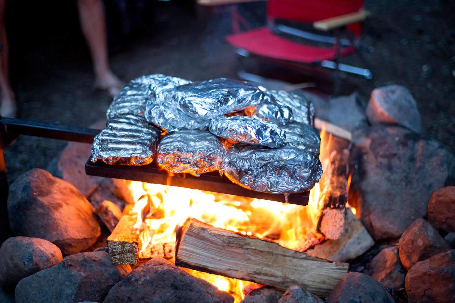food in foil over campfire