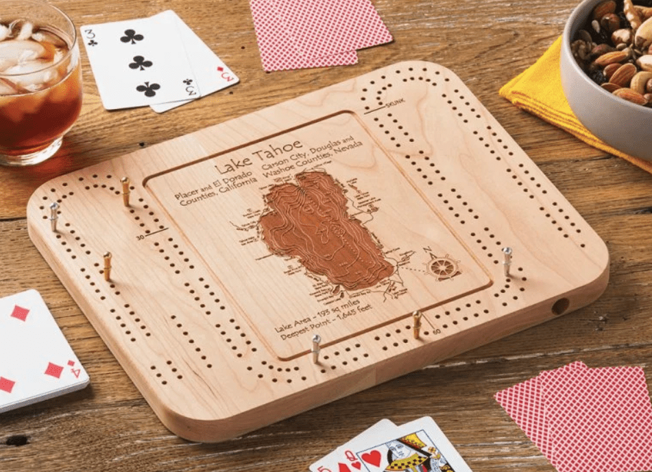 cribbage game board with a map engraved in the middle