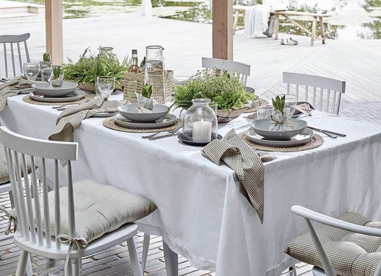 white and cream table setting on outdoor dining table