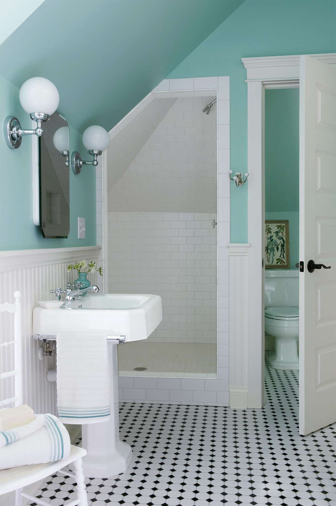 teal bathroom with white tile shower
