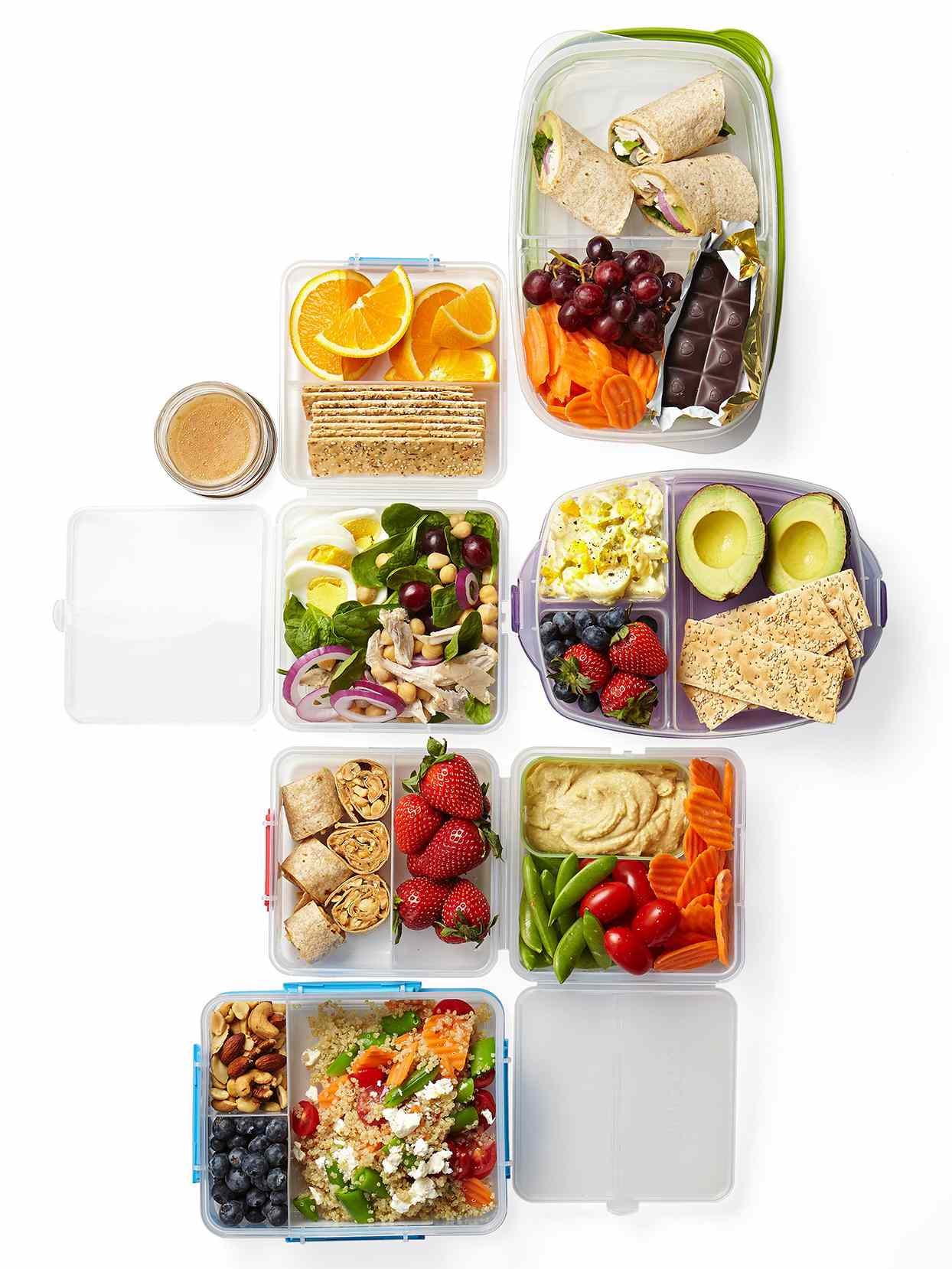Meal prep in plastic food storage containers on white surface