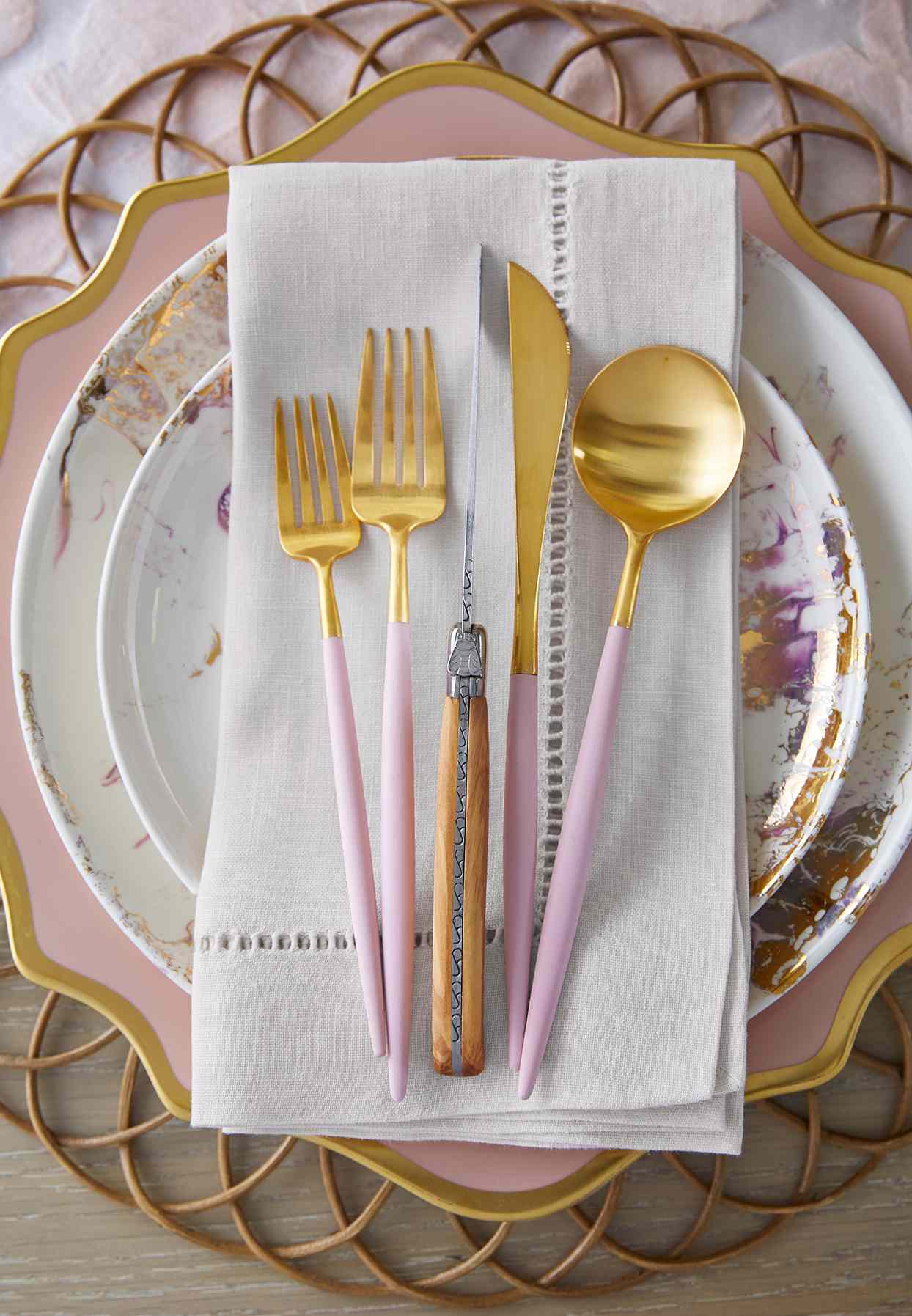 close up gold utensils napkin plates