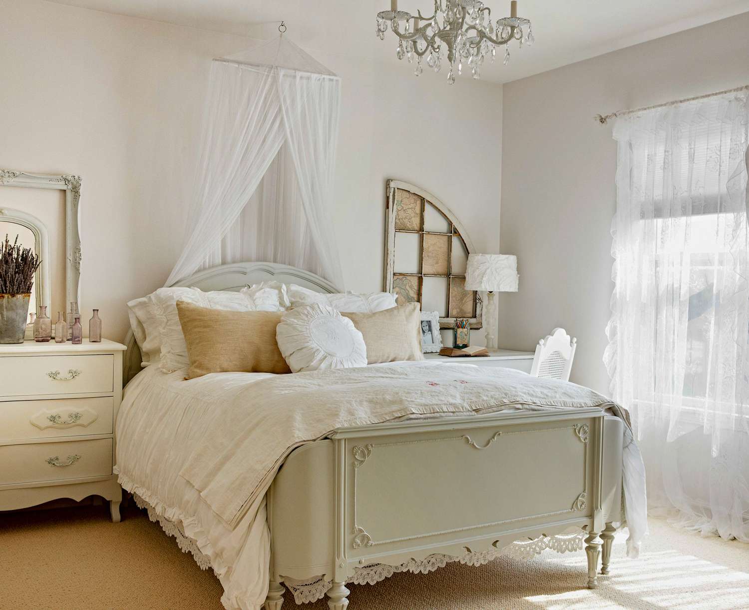 airy bedroom with canopy and antique accents