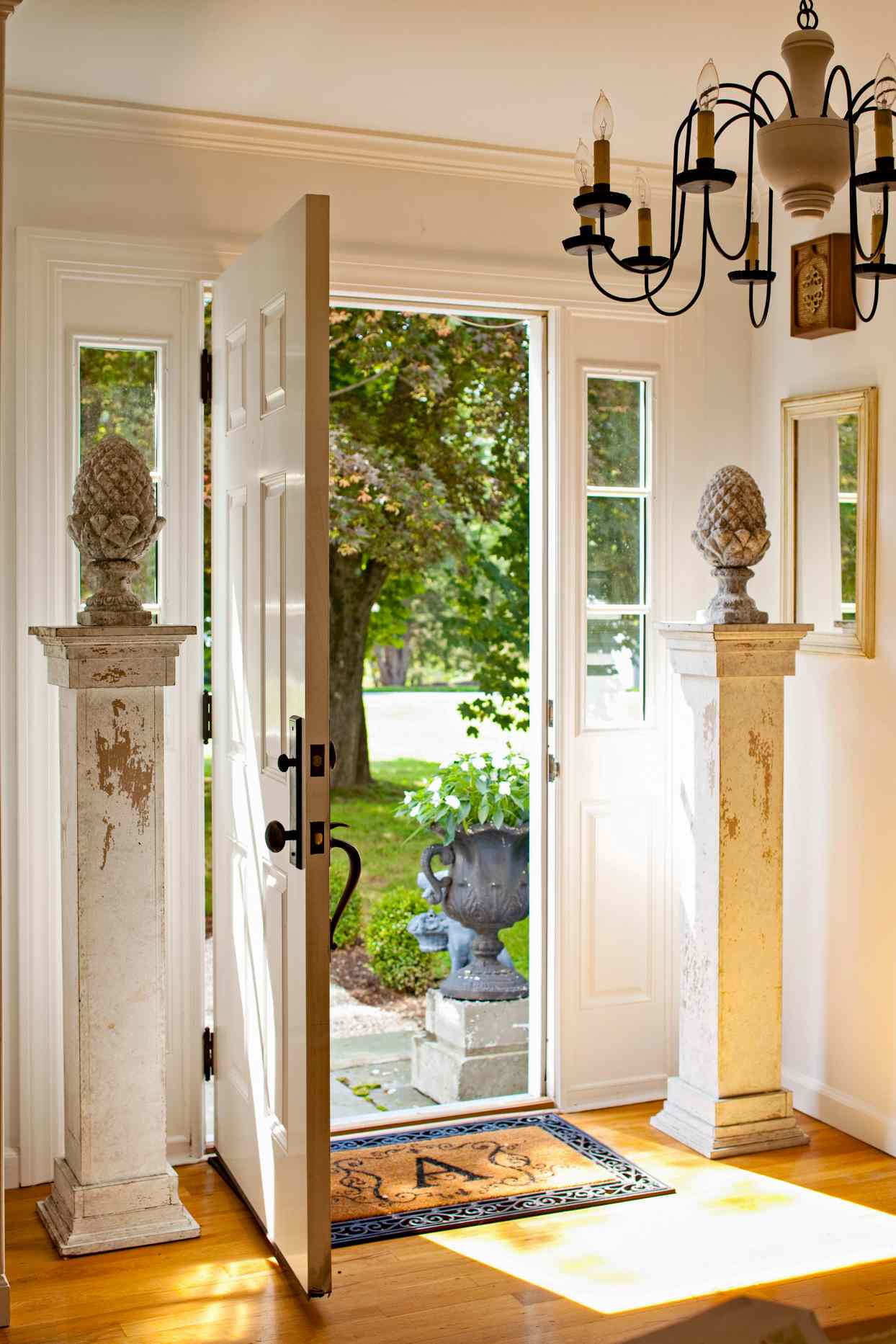 open front door with rustic decorative statues