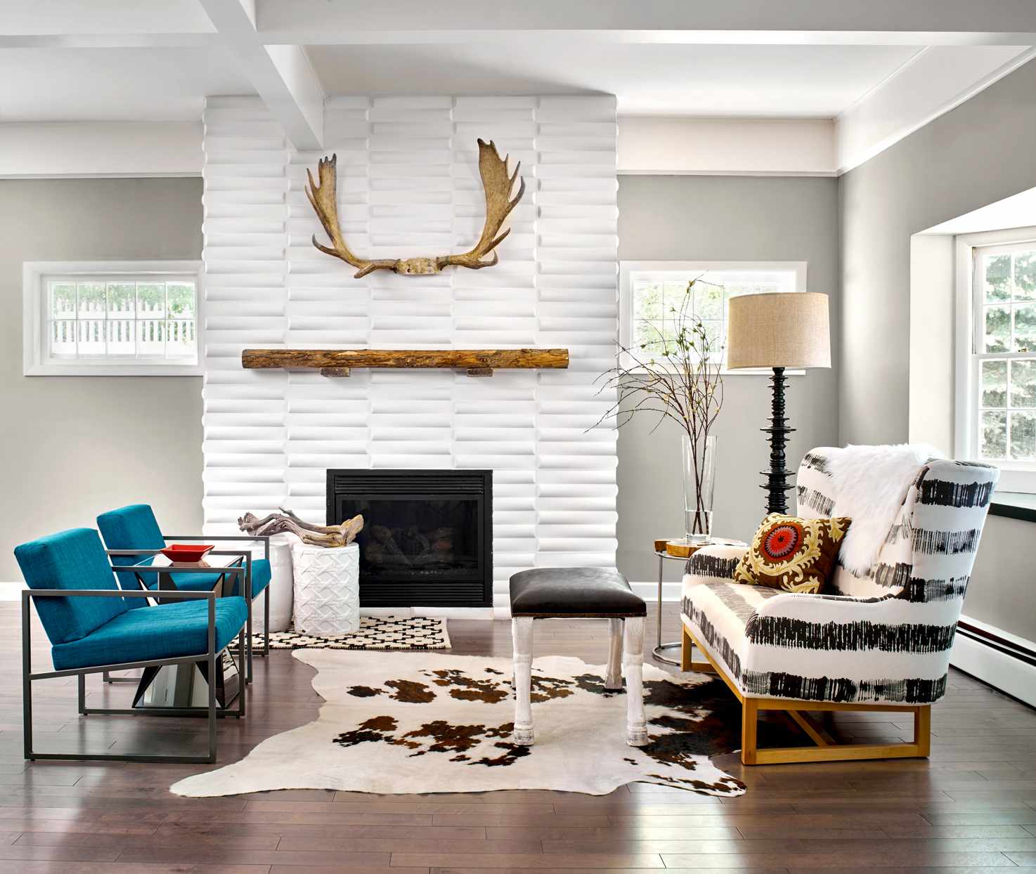 living room with light grey walls and white fireplace