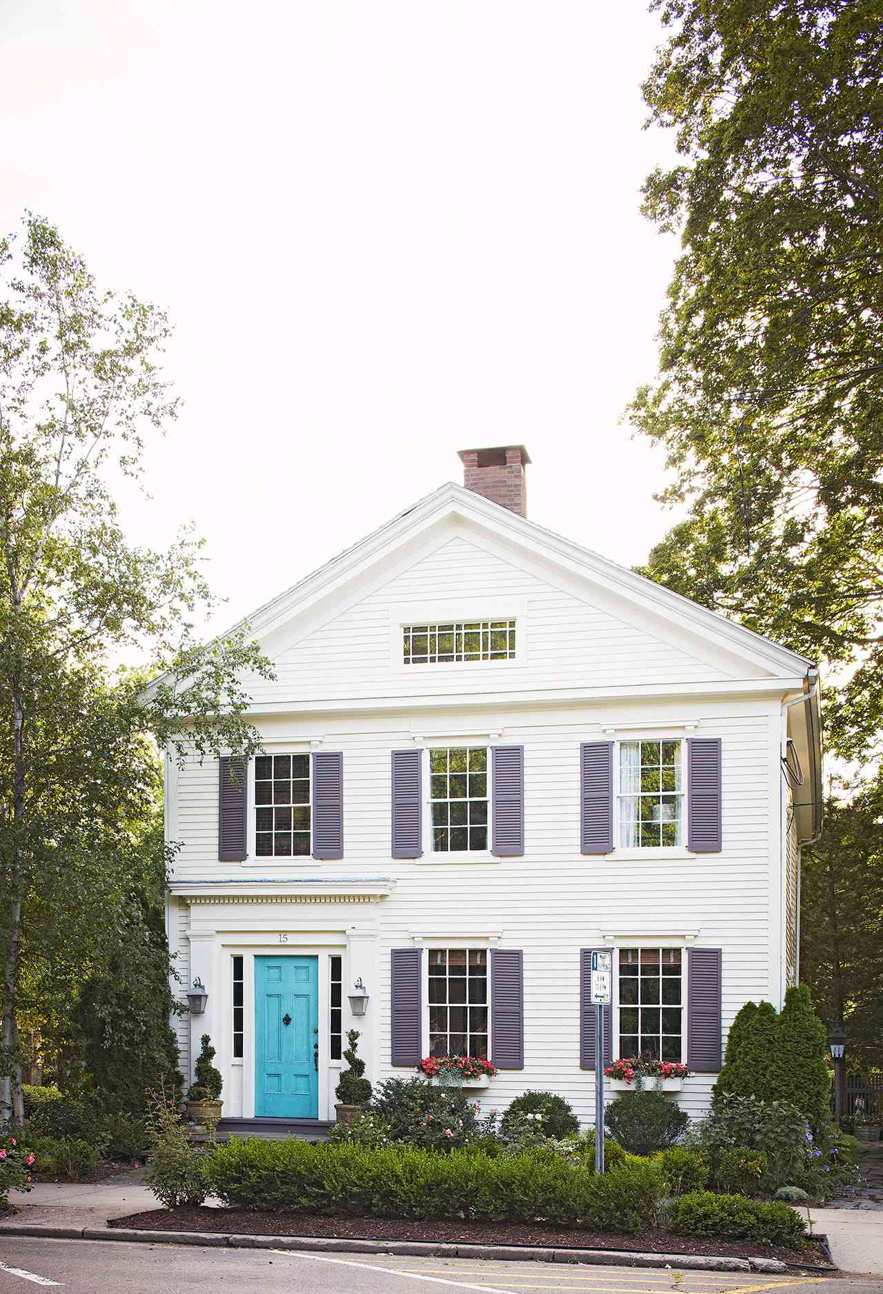 colonial-style home blue door purple shutters