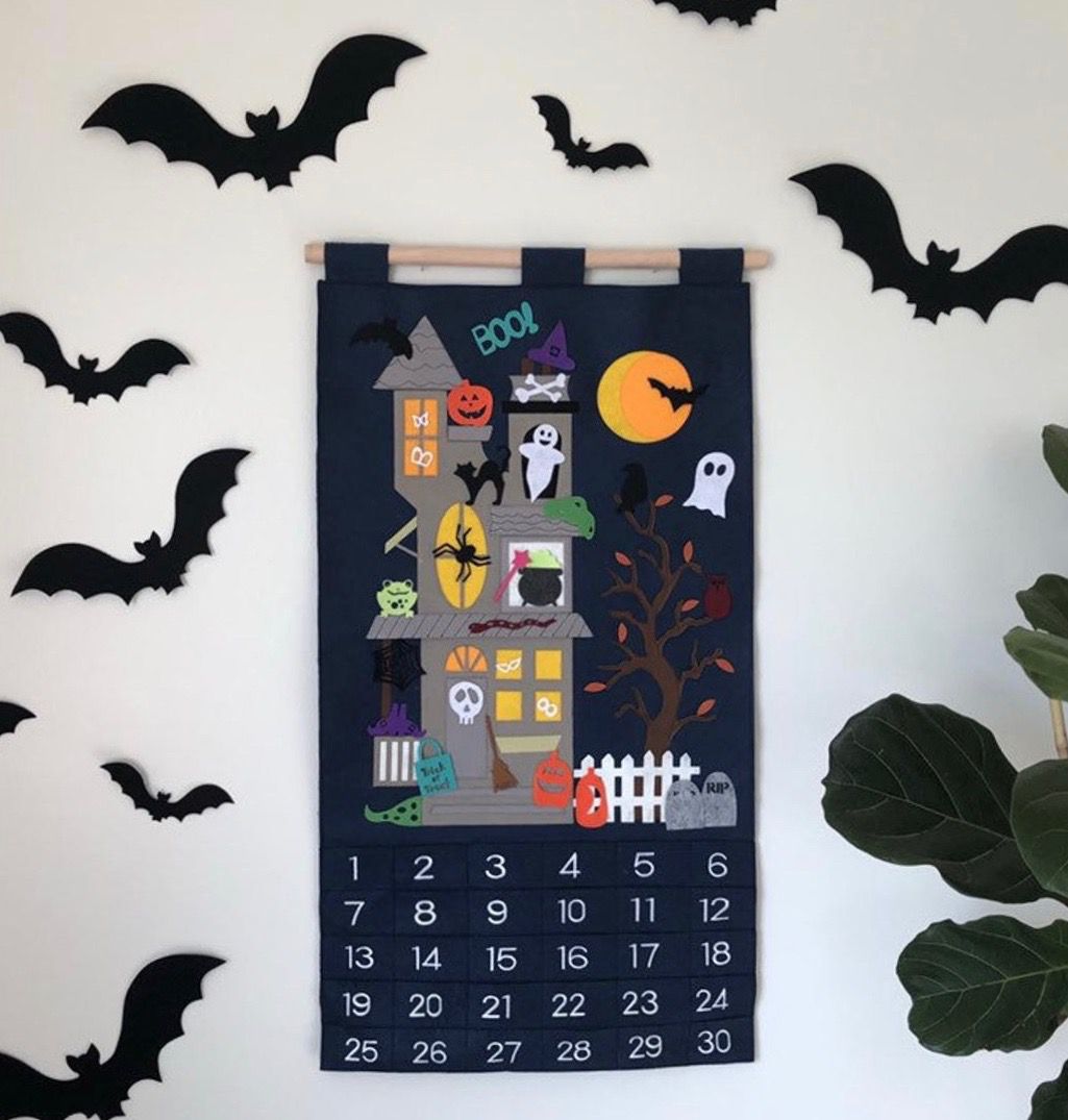 black felt advent calendar with haunted house on it